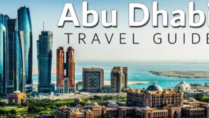 Panorámica de Abu Dhabi con un prominente skyline de rascacielos junto al mar, edificios palaciegos y arquitectura árabe visibles en primer plano que sugieren lujo, modernidad y turismo, Ventajas y desventajas de vivir en Abu Dhabi: descubre si es para ti