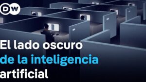 Imagen que muestra una red de cubículos oscuros con trabajadores sentados frente a pantallas iluminadas, transmitiendo anonimato, monotonía y vigilancia en entornos digitales, acompañada del titular sobre el lado oscuro de la inteligencia artificial y destacando Ventajas y desventajas de las ETT: descubre si realmente convienen.