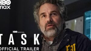 Primer plano de un hombre de mediana edad con barba y expresión preocupada, vistiendo una chaqueta con las siglas FBI en un ambiente oscurecido junto a logotipos y texto promocional de HBO Max que sugiere un tráiler de drama, Ventajas y desventajas de HBO Max: ¿vale la pena la suscripción?