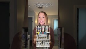 Retrato de una mujer joven de cabello largo, lacio y rubio oscuro que sonríe frente a una habitación con luz cálida y un recuadro superpuesto mostrando una estantería de champús Pantene en tienda y texto superior en inglés sobre daño capilar, una imagen pensada para ilustrar reseñas y comparativas como Ventajas y desventajas del shampoo Pantene: ¿realmente funciona?