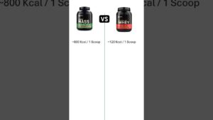 Imagen comparativa accesible con fondo blanco que muestra dos botes de suplementos y un icono "VS" en el centro: a la izquierda un envase tipo mass con etiqueta verde indicando aproximadamente 800 Kcal por scoop y a la derecha un bote de Gold Standard Whey con etiqueta roja indicando aproximadamente 120 Kcal por scoop, separados por una línea vertical, Whey protein gold standard ventajas y desventajas para ti.